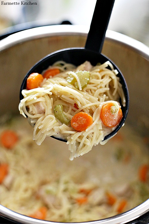 black ladle full of chicken noodle soup in the instant pot