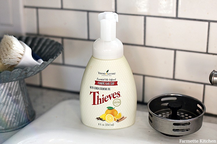 Bottle of Young Living Thieves Foaming Hand Soap beside sink