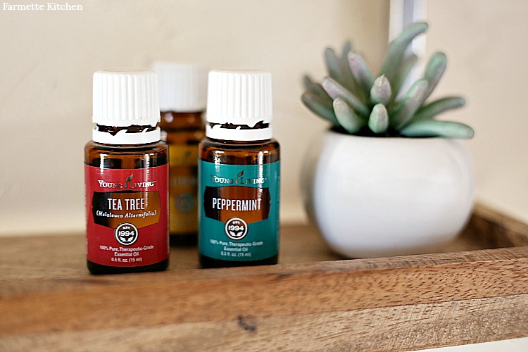 Bottles of Young Living Essential Oils- Tea Tree, Peppermint, and Lemon