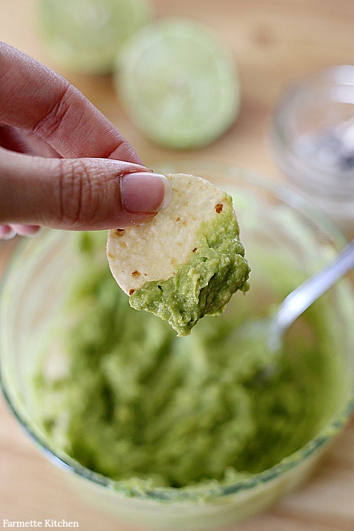 guacamole scooped up with a chip