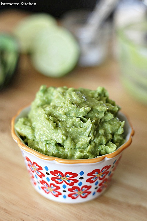 decorative bowl overflowing with a scoop of guacamole