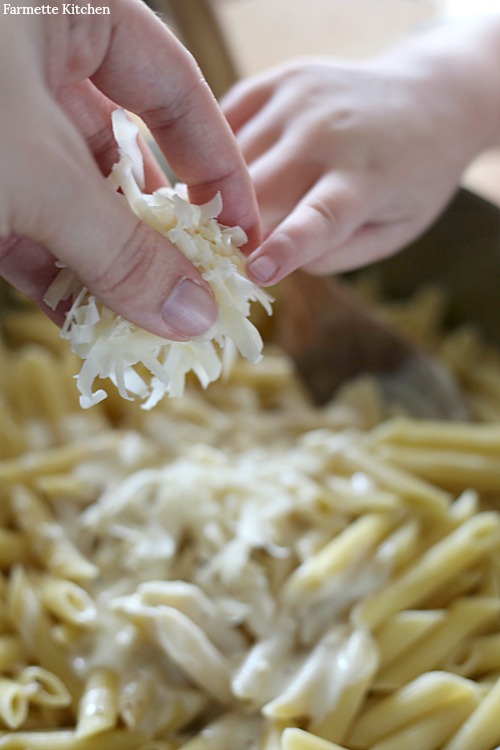 adding cheese to pasta