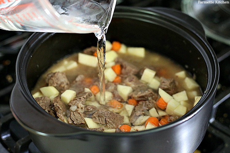 adding water to meat and vegetables for Korean curry rice