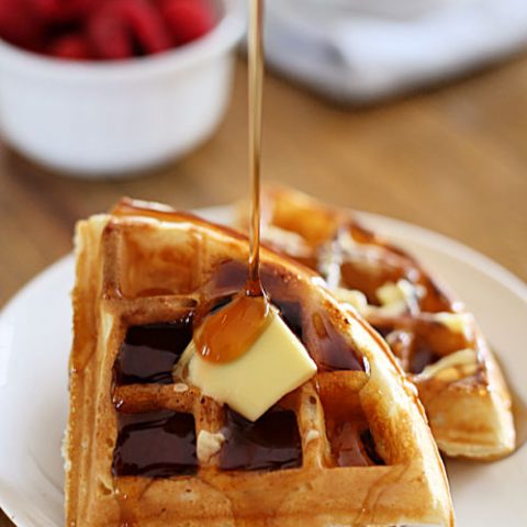 waffle triangles on a plate with butter and syrup