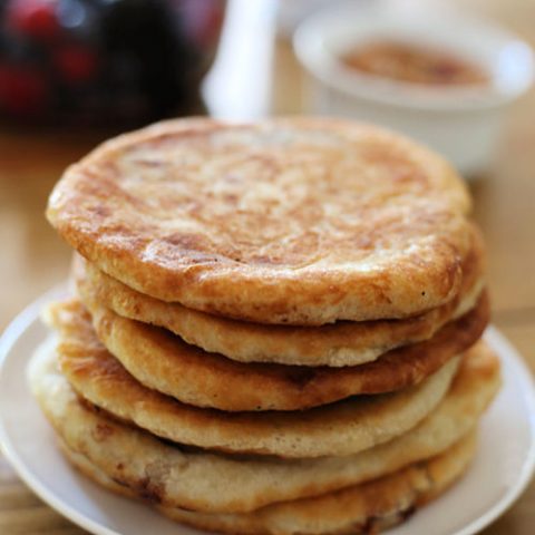 a stack of hotteok Korean pancakes on a plate