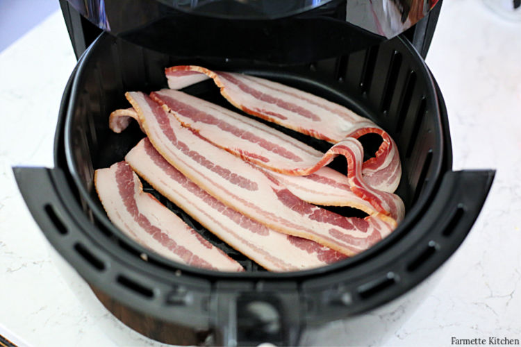 raw bacon in an air fryer basket