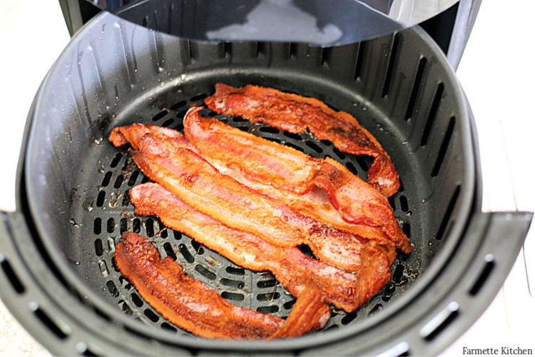 cooked bacon in an air fryer basket