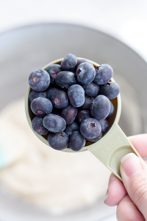 measuring cup full of blueberries