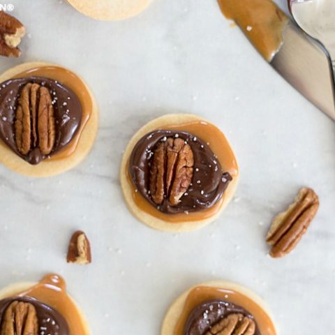 shortbread cookies topped with caramel, chocolate, and pecans