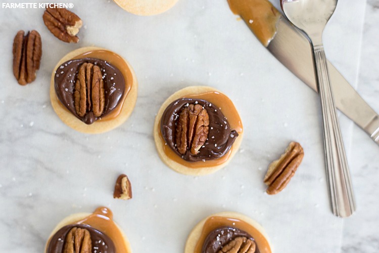 shortbread cookies topped with caramel, chocolate, and pecans