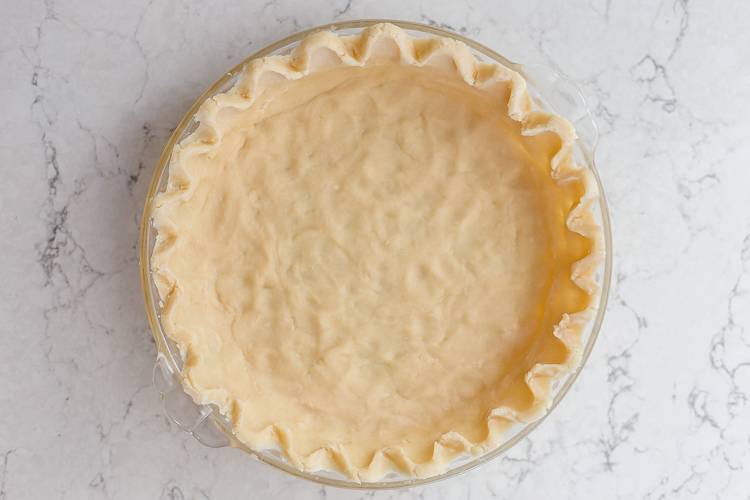 an unbaked all butter pie crust sitting on the counter