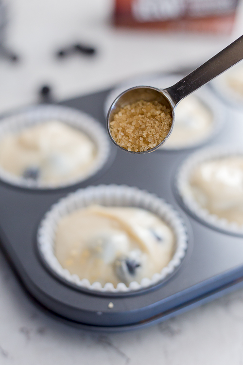 sprinkling sugar over raw muffin batter