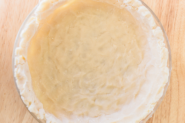 pie crust that has been pushed into a pie plate by hand