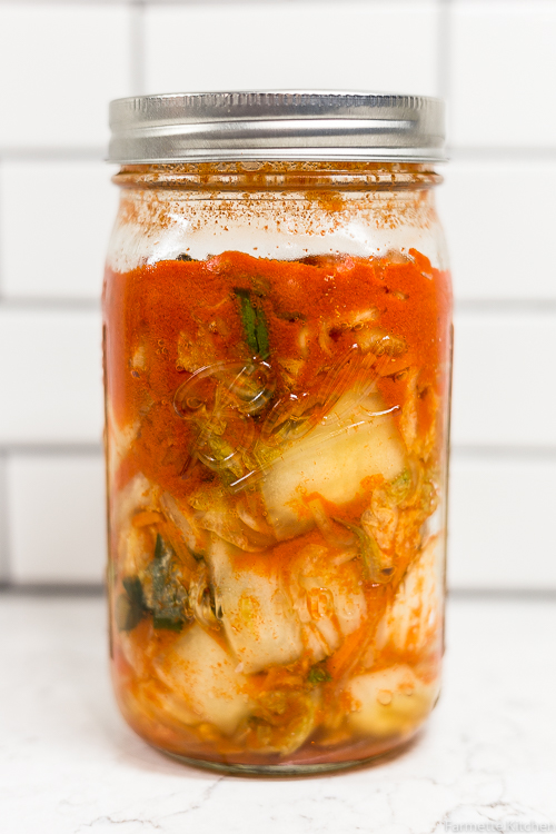 a large mason jar full of kimchi