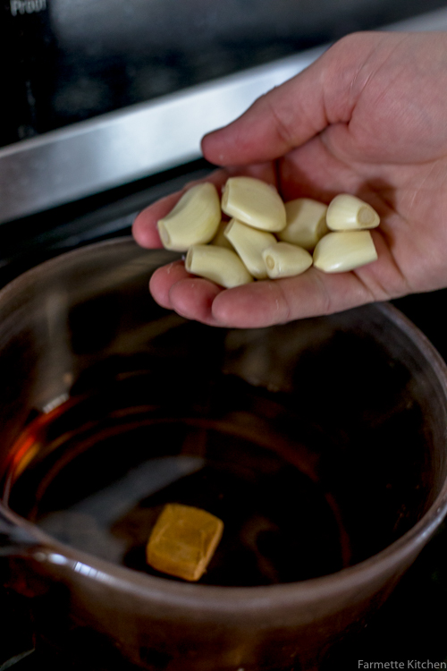 garlic cloves added to a pot