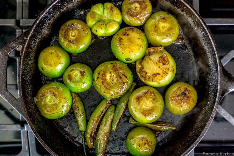 roasted tomatillos in a cast iron skillet