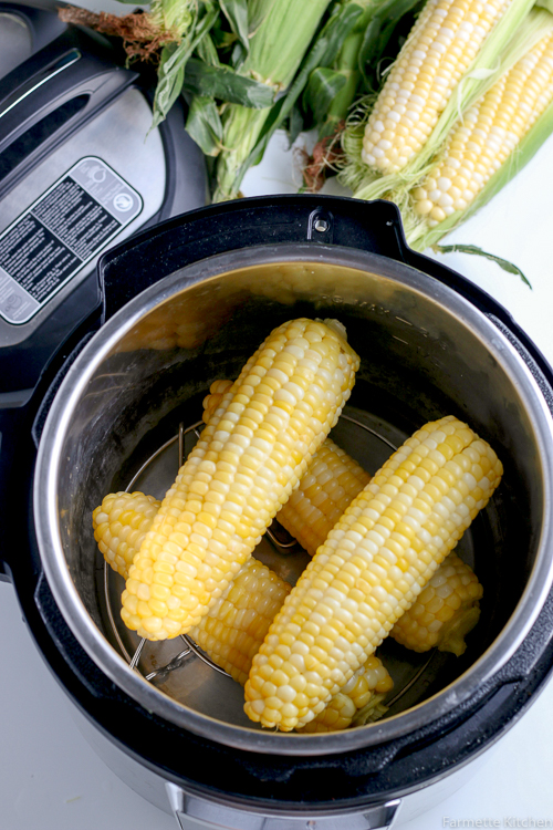 four ears of cooked corn in a pressure cooker