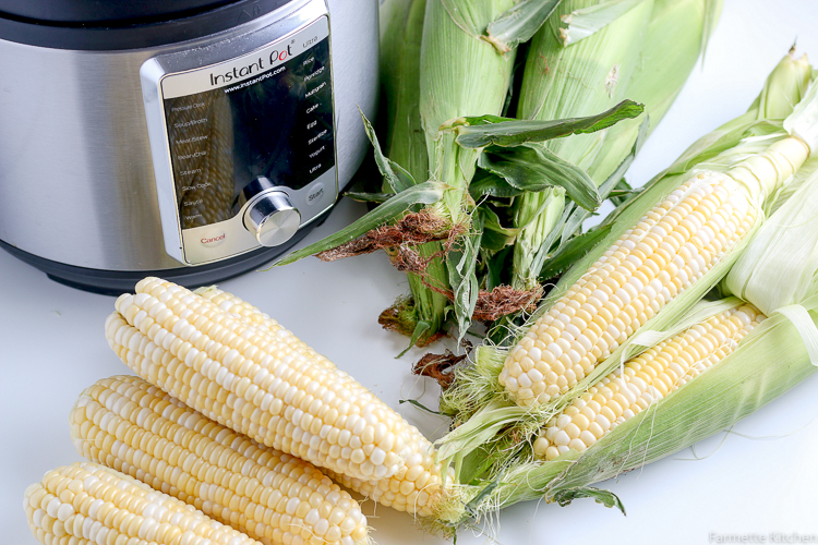 shucked corn next to unshucked corn