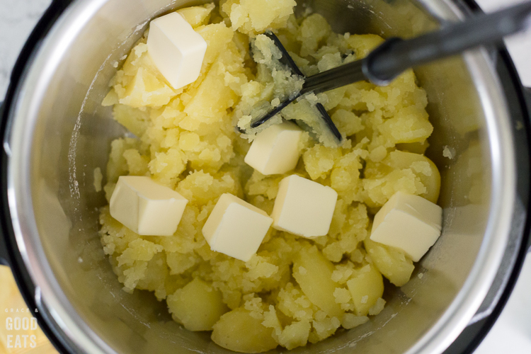 mashed potatoes with pats of butter in the Instant Pot