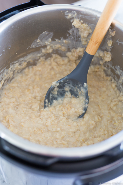 cooked oatmeal in an Instant Pot with a wooden spoon