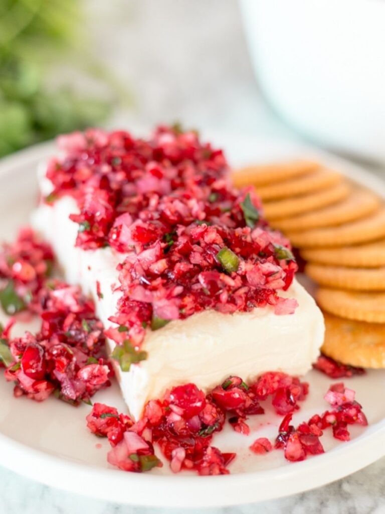 Cranberry salsa made with fresh cranberries, red onion, jalapeño, and cilantro tossed with sweetened lime juice. Serve this super easy dip over softened cream cheese and watch it disappear!