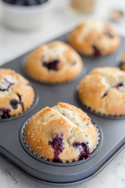 Blueberry Sour Cream Muffins in a muffin tin
