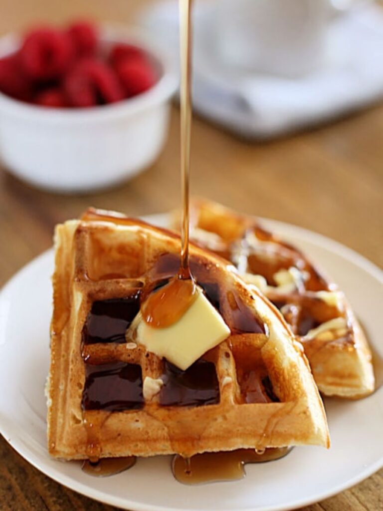 waffle on a plate with butter and syrup