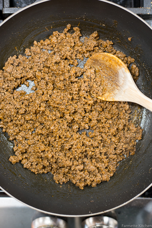 cooked ground beef in a cast iron skillet