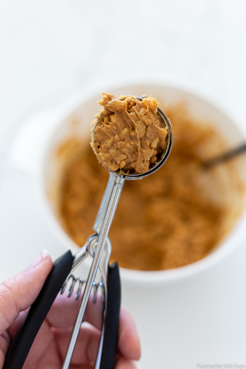cookie scoop of peanut butter mixed with crispy rice cereal